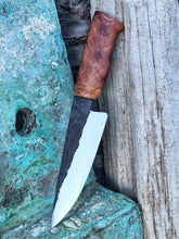 Knife with a wooden handle on a textured surface
