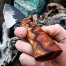 Benjamin holding the Chef Knife, showing off the lightening bolt in the redwood grain.
