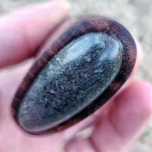 Oval-shaped fossilised whale bone stone knife pommel held in Benjamins hand
