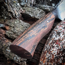 Victorian wooden wagon wheel handle on a rustic aged wagon wheel background