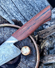 Wagon Wheel Chef Knife closeup of its wooden wagon wheel spoke handle, photographed on the Victorian wagon wheel its materials came from.