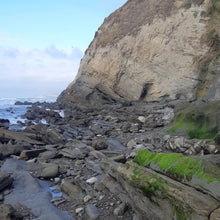 Rocks and cliffs on the Wairarapa coastline with ocean and sky.