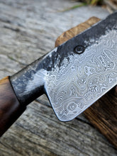 Close-up of a Damascus steel blade pattern on a wooden background