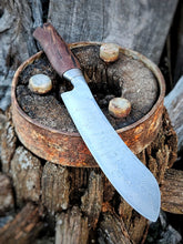 Wagon Wheel Butcher Knife with a wagon wheel wooden spoke handle with a wagon wheel wrought iron clad blade on a Victorian wagon wheel background