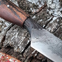 Knife detail of the wagon wheel wood handle and integral blade wagon wheel wrought iron detail
