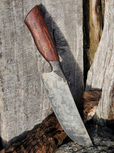 Knife with a wagon wheel wood handle on a wooden surface