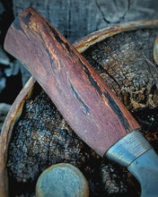 Wagon wheel wooden spoke handle detail showing off the wood grain with a Victorian wagon wheel in the background
