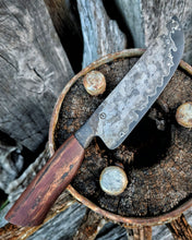 Knife with a wagon wheel wood handle on a victorian rustic wagon wheel surface