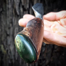 Benjamin holds the hunting knife he hand crafted, showing off the Hokitika Kawakawa Pounamu cabochon he carved to fit the pommel.