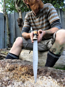 Serpentine Carving Seax in the hand of the maker Benjamin Madden