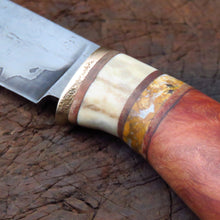 Storm jasper go mai hunter detail of wood stone antler bronze and blade