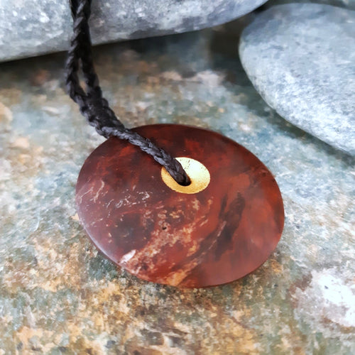 Sun and Moon Disc from Red Jasper we found at our favourite local fossicking spot. This side shows the gold leaf gilded centre.