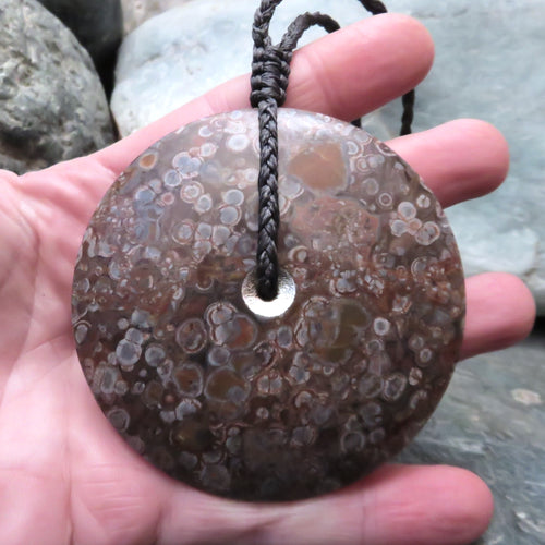 Sun and Moon Disc Pendant. Held in Marisa's hand to show its size.